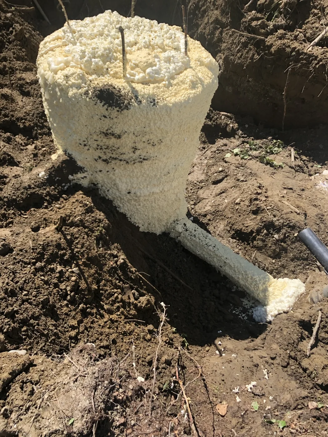 Concrete cylinder set in an excavated area