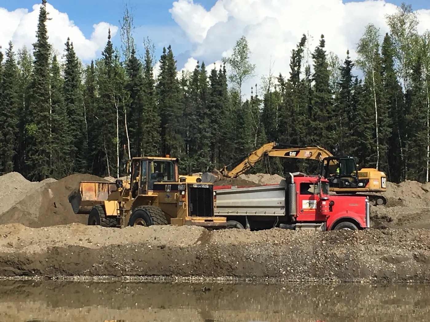 Heavy equipment and a truck at a large earthwork site